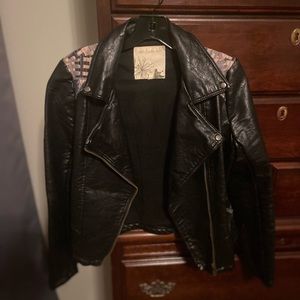 Like new, leather jacket with Navajo print detail.
